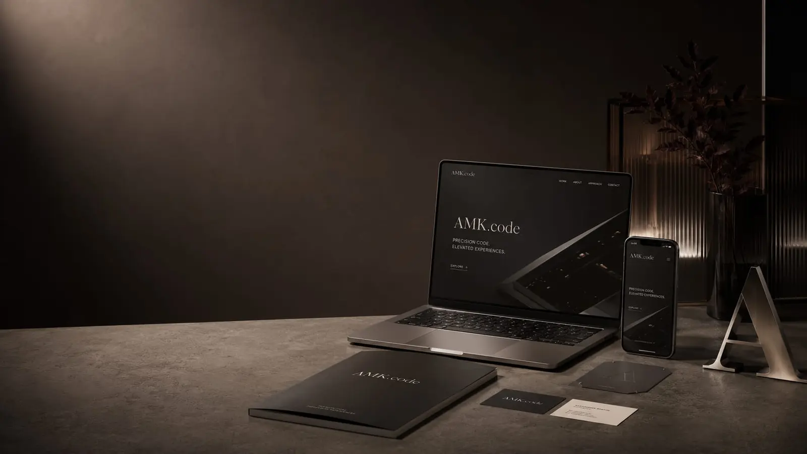 AMK.code studio branding — a dark scene with a laptop and identity materials